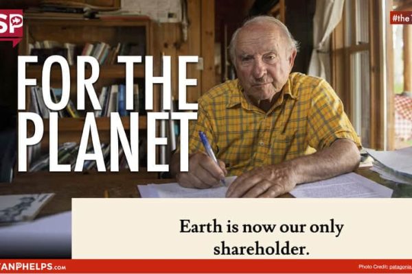 An elderly man in a yellow plaid shirt sits at a wooden table with papers. The text reads, "For the planet. Earth is now our only shareholder.